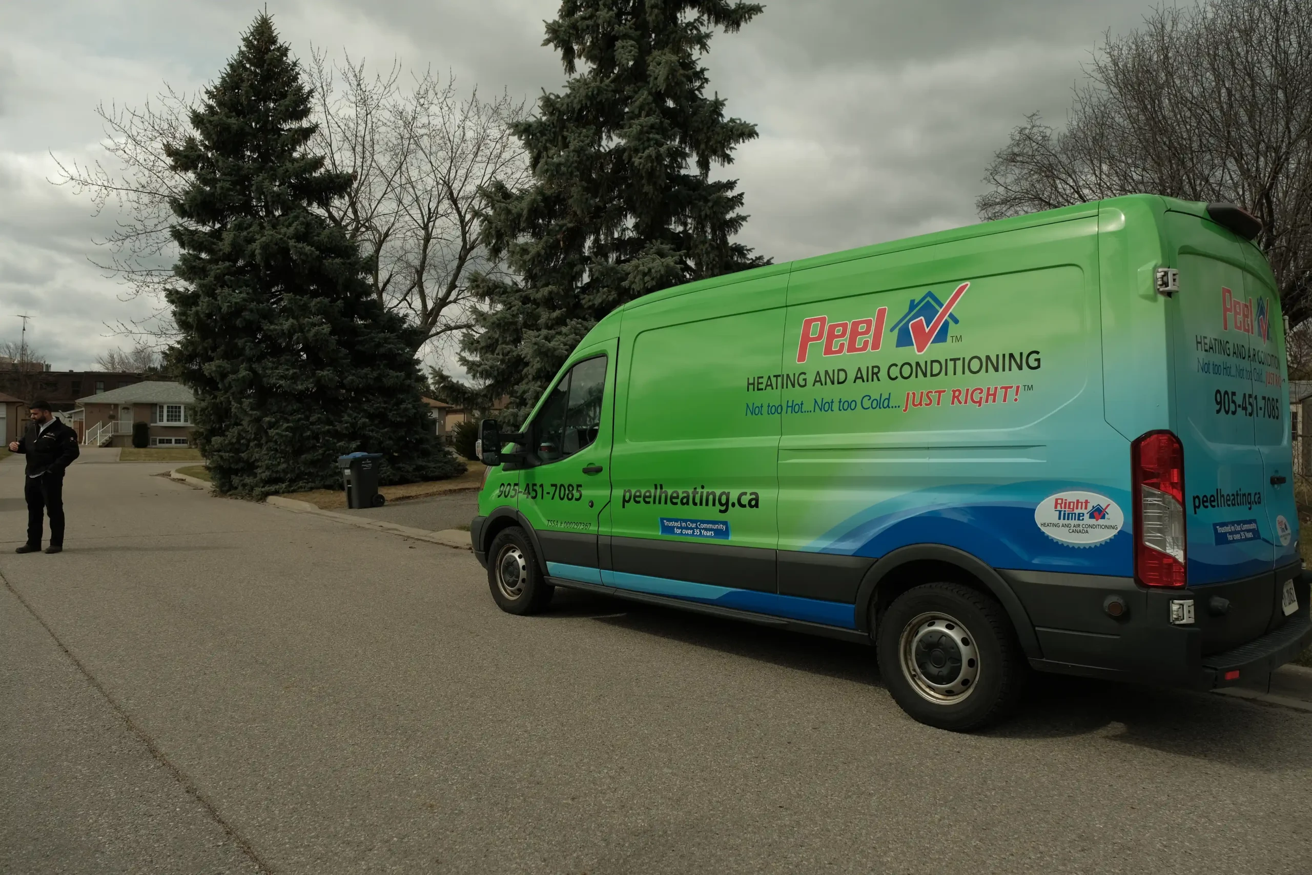 A Peel Heating service truck parked in a residential driveway during a fall furnace maintenance visit.